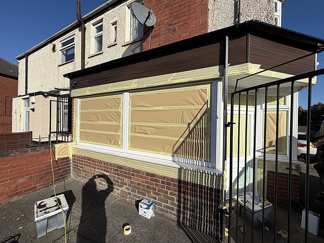 Commercial spraying in progress — UPVC windows and frames of a Grimsby beauty and spa premises carefully masked and prepared on site