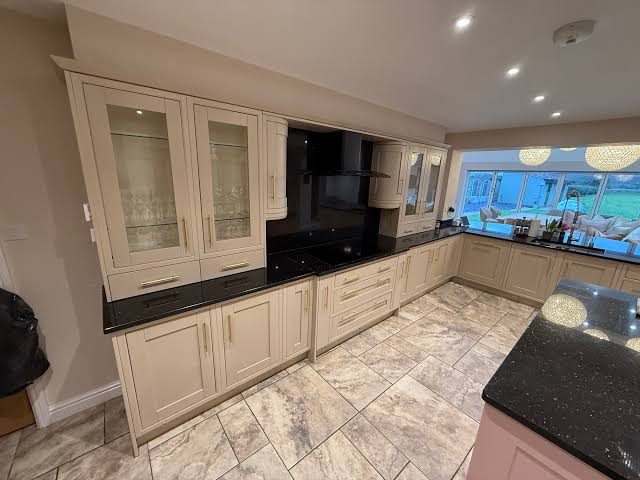 Cream in-frame kitchen with glazed display cabinets and sprayed finish