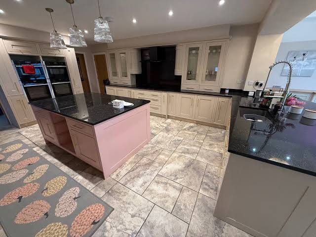 In-frame kitchen with a bespoke pink feature island and cream sprayed cabinetry