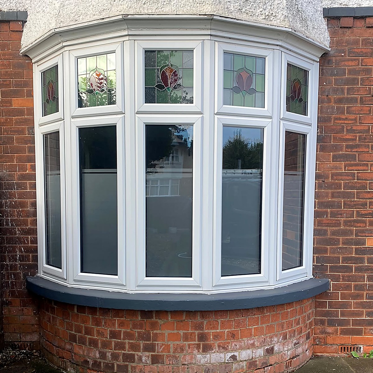 UPVC bay window spraying before and after — white frames, then anthracite grey