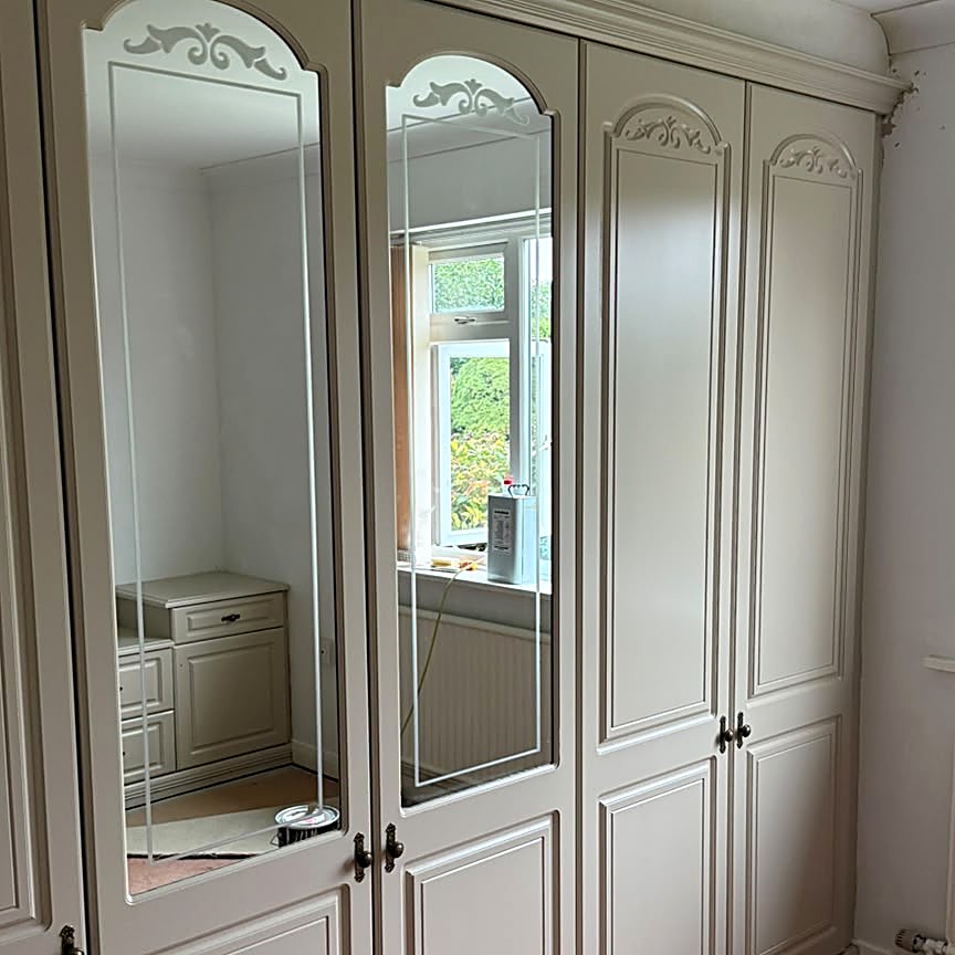 Wardrobe spraying in Spilsby — mahogany sprayed in soft cream. Drag to compare