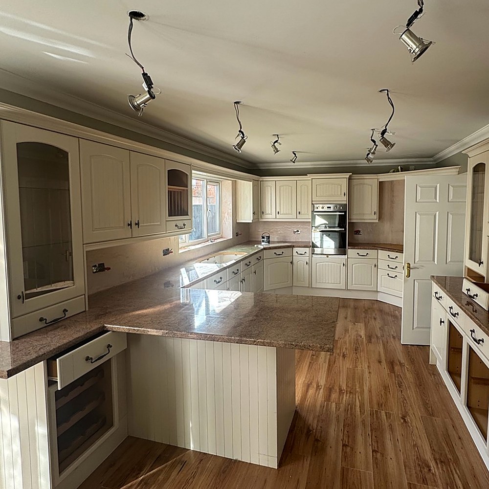 Kitchen spraying Cleethorpes — before: dated kitchen with dark wood floor and brown worktops