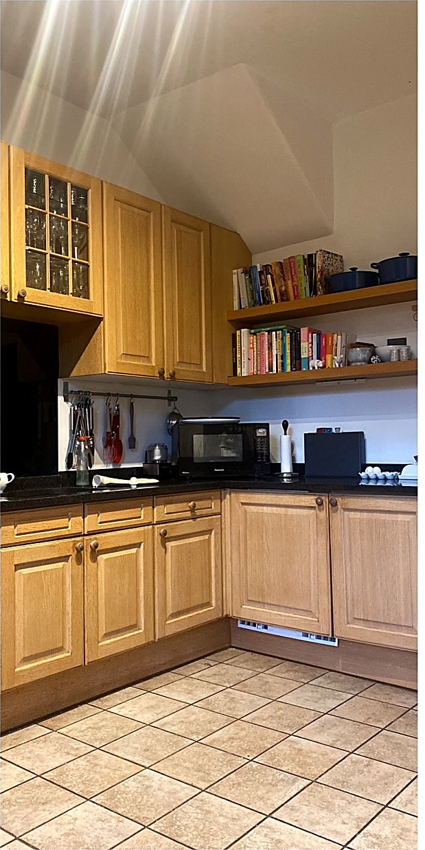 Kitchen respray in Lincoln — before: golden oak cabinets. After: sprayed in Farrow and Ball Vert de Terre